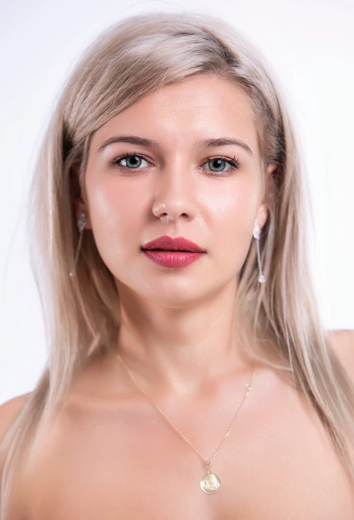 Blonde FEMMENORDIC model with silky hair sat in a bathtub.