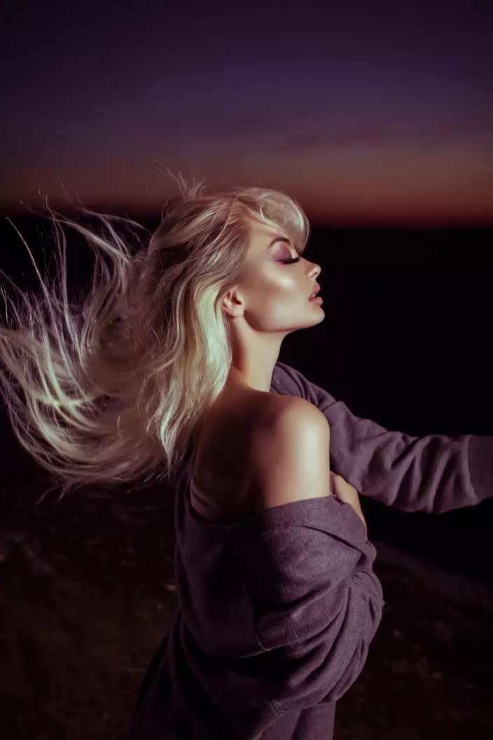 Blonde FEMMENORDIC model with silky hair sat in a bathtub.